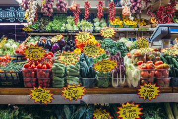 Vegetables and fruits stall on Mercato Delle Erbe indoor food market in Bologna city, Italy - obrazy, fototapety, plakaty