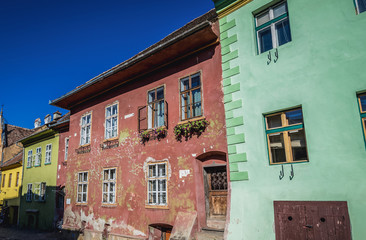 Fototapeta na wymiar Row of tenement houses on School Street in historic part of Sighisoara city located in Mures County, Romania