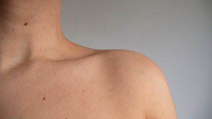 Caucasian female neck and shoulder.
