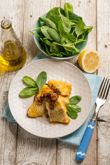 cod baked with onions and fresh spinach salad