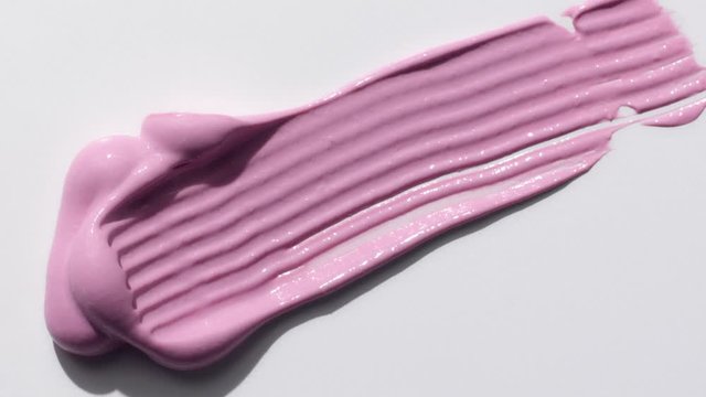 liquid blush creamy blush texture drop smudged by stainless steel spatula on white