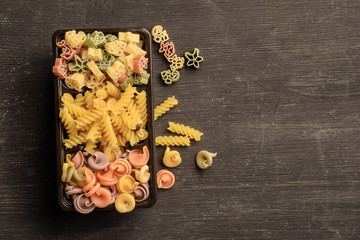Different types of raw pasta in a box