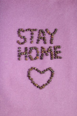 Stay home words made of coffee beans. Concept of self-isolation during the Covid-19 coronavirus pandemic. 