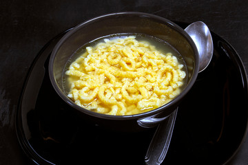 traditional italian pasta in broth passatelli
