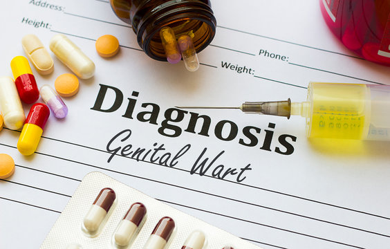 Genital Wart - Diagnosis written on a piece of white paper with medication injection, syringe and pills