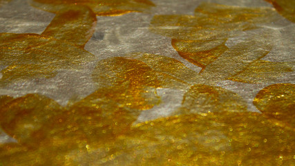 Blurred shining Golden texture acrylic paint on cardboard. Hand drawing, real texture, close-up.