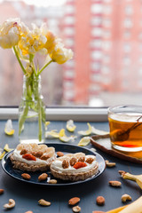 spring breakfast at home. cup of tea with lemon and banana and almond toast. breakfast at home. breakfast idea. simple breakfast decoration