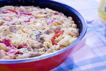 Rice paella cooked with chicken, seafood and vegetables