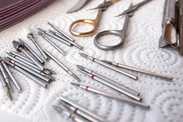 Manicure tool. Used professional tools. A lot of used cutters, pushers, nail files and scissors.
