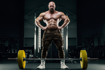 Fototapeta na wymiar Bodybuilder athletic man back muscles deadlift