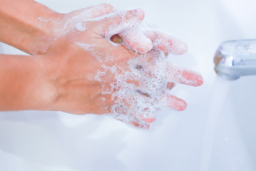 young women washing hands with soap rubbing fingers
