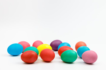Easter multicolor eggs isolated on a white background. Rainbow. Copy space. Flat lay. Side view.