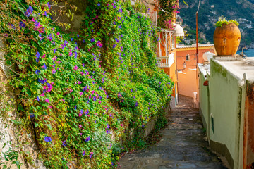 Fototapeta na wymiar Typical narrow street and colorful houses in city of Positano