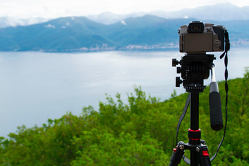Photo camera on a tripod captures the Bay of Kotor Montenegro.