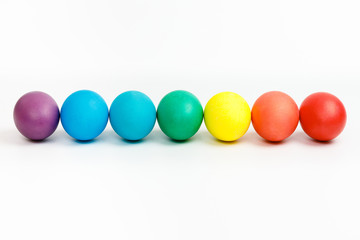 Easter multicolor eggs isolated on a white background. Rainbow. Copy space. Flat lay. Top view.