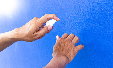 Man uses a spray of alcohol to get rid of bacteria and viruses, Inhibition and prevention of...