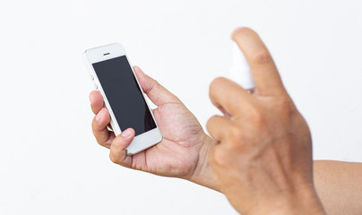 Men use alcohol spray to get rid of bacteria and viruses on mobile phones, Inhibition and prevention of Covid-19 virus infection using 70 percent alcohol, protect virus concept.