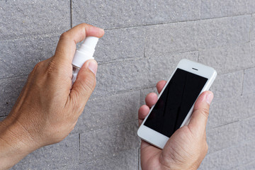 Men use alcohol spray to get rid of bacteria and viruses on mobile phones, Inhibition and...
