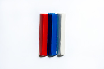 Three multi-colored plasticine bars on a white background. material for children's creativity. isolate.