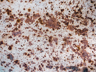 Worn rusty metal surface with cracking texture background.