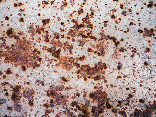 Worn rusty metal surface with cracking texture background.