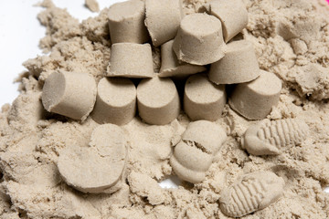 Obraz premium many small towers of kinetic sand. play with a child.