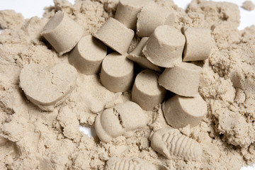 Fototapeta na wymiar many small towers of kinetic sand. play with a child.