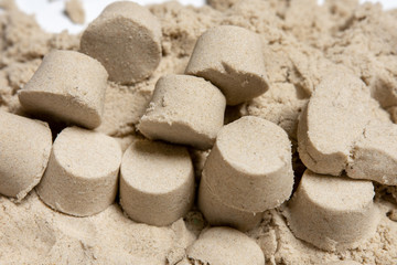 Fototapeta na wymiar many small towers of kinetic sand. play with a child.