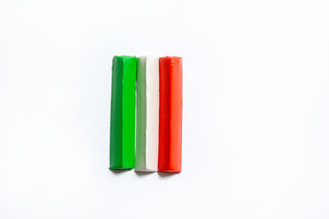 Three multi-colored plasticine bars on a white background. material for children's creativity. isolate.