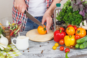 Woman cooks at the kitchen, body part, blurred background