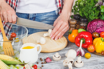 Woman cooks at the kitchen, body part, blurred background