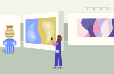 Gallery of modern art with visitors. Abstract paintings hanging on wall in exhibition or museum room.