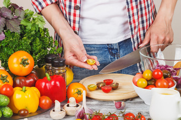 Woman cooks at the kitchen, body part