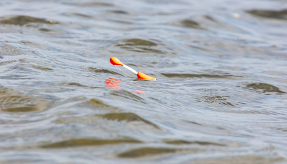 A fishing float floats on the waves. © schankz