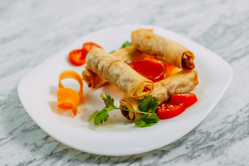 pancakes with meat and spicy sauce on a marble table