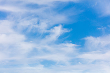 Naklejka na ściany i meble White clouds on a blue sky as background