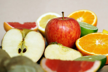 Apples, citrics and giner lying on a table
