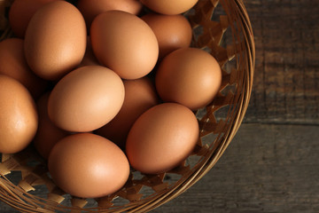 Eggs in a basket on a wooden background