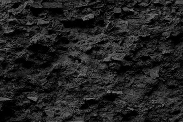 Fototapeta na wymiar Background of black vintage stone wall texture, natural pattern