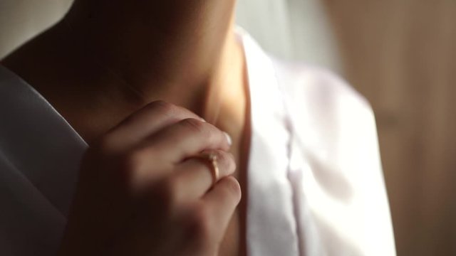 hand of the bride near the neckline