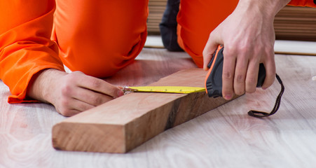 Contractor working on laminate wooden floor