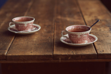 two cups of tea on a wooden table