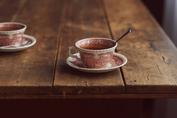 two cups of tea on a wooden table