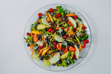 Fruit salad on a plate, healthy food isolated on white background