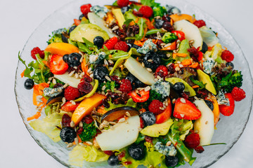 Fruit salad on a plate, healthy food isolated on white background