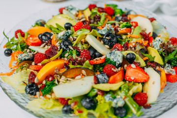 Fruit salad on a plate, healthy food isolated on white background