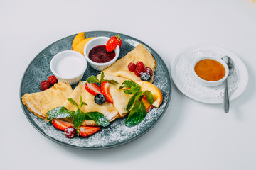 pancakes with strawberries, raspberries and jam, breakfast, healthy food isolated on white background
