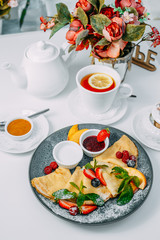 pancakes with strawberries, raspberries and jam, breakfast, healthy food on white background