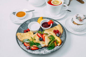 pancakes with strawberries, raspberries and jam, breakfast, healthy food on white background