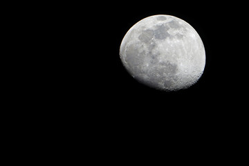 View of the moon and its craters over a dark night sky